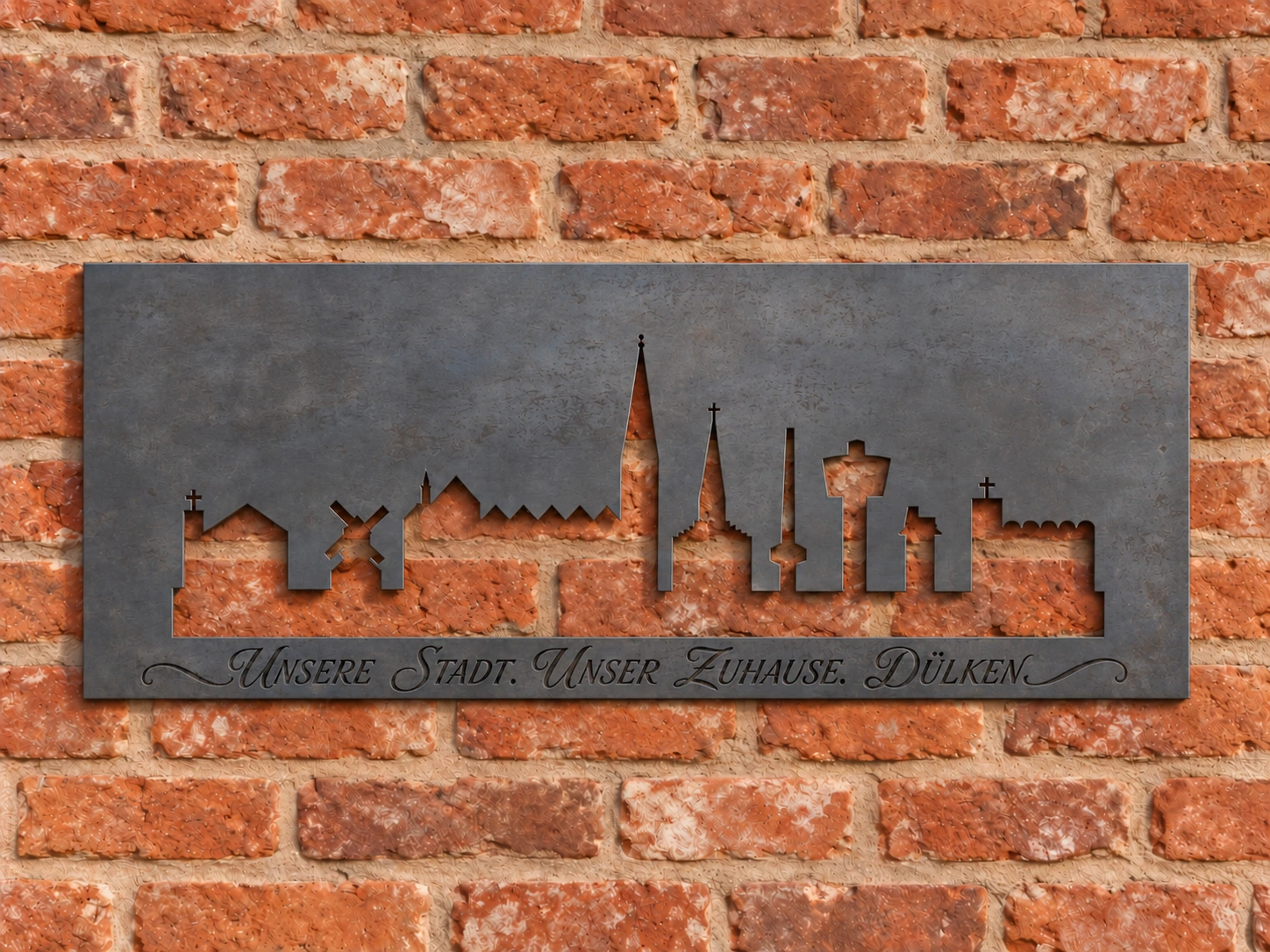 Dülkener Skyline aus Stahl mit schwarz ausgefüllter Gravur: Unsere Stadt. Unser Zuhause. Dülken.